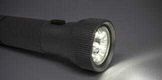 Wie lange halten die Akkus? Angeschaltete Taschenlampe auf Oberfläche